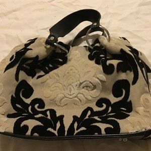 White and black purse with black handles